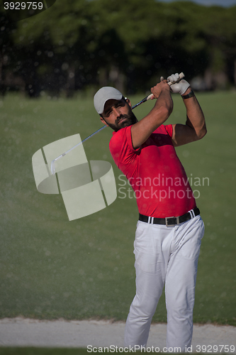 Image of golfer hitting a sand bunker shot