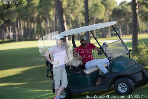 Image of couple in buggy on golf course