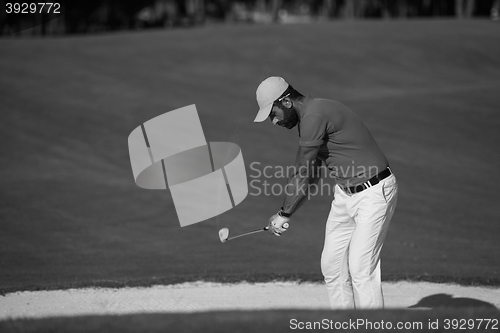 Image of golfer hitting a sand bunker shot