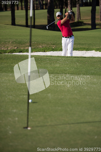 Image of golfer hitting a sand bunker shot