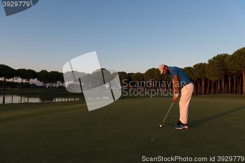 Image of golfer  hitting shot at golf course