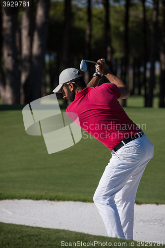 Image of golfer hitting a sand bunker shot