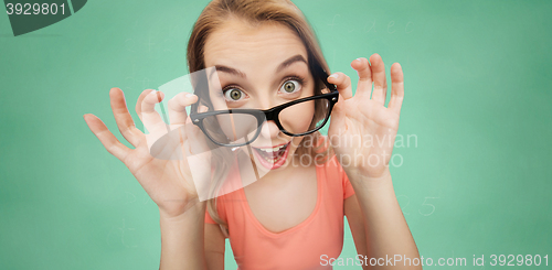 Image of happy young woman or teenage girl in eyeglasses