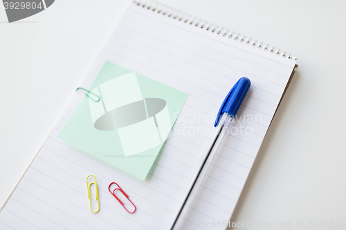 Image of close up of notebook with pen and bank paper