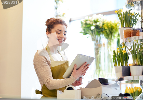 Image of woman with tablet pc computer at flower shop