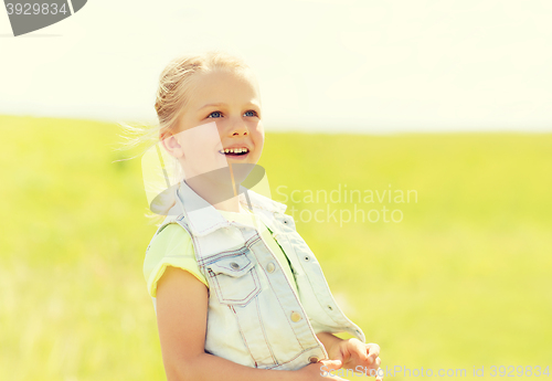 Image of happy little girl outdoors at summer