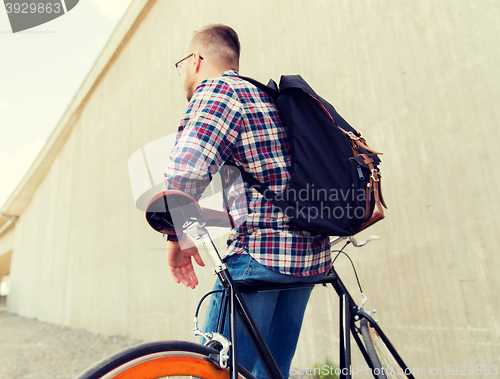 Image of hipster man with fixed gear bike and backpack