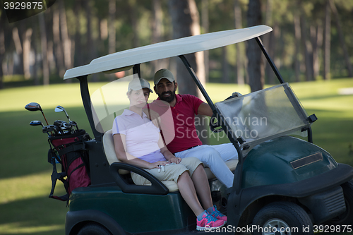 Image of couple in buggy on golf course