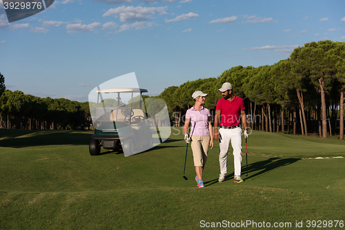 Image of couple walking on golf course