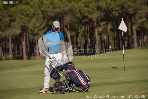 Image of golf player walking with wheel bag