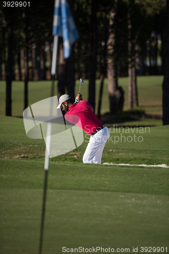 Image of golfer hitting a sand bunker shot