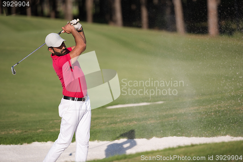 Image of golfer hitting a sand bunker shot