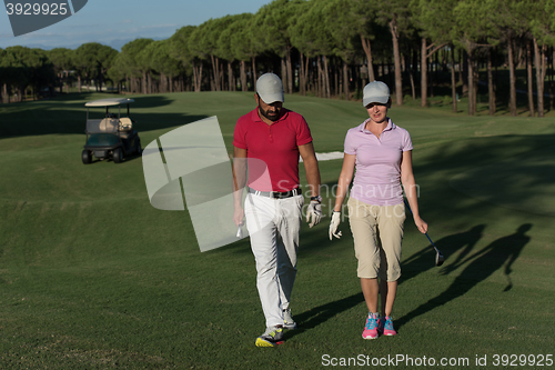 Image of couple walking on golf course