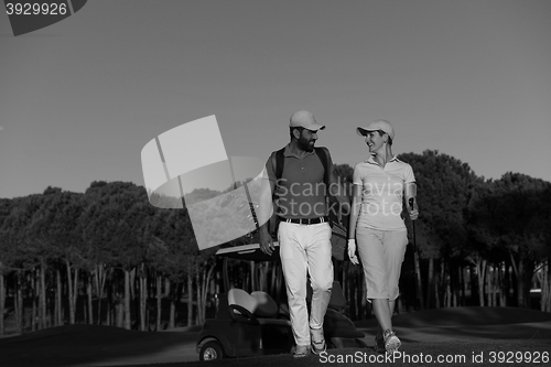 Image of couple walking on golf course