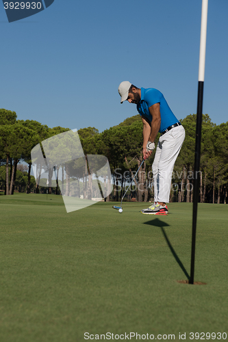 Image of golf player hitting shot at sunny day