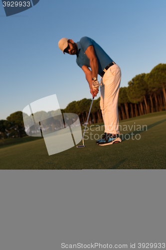 Image of golfer  hitting shot at golf course