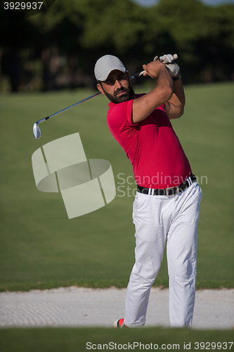 Image of golfer hitting a sand bunker shot