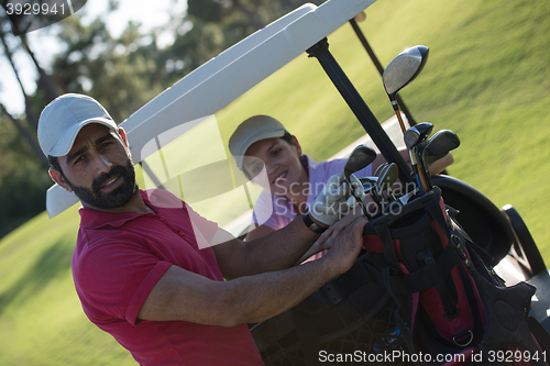 Image of couple in buggy on golf course