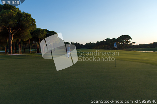 Image of golfer hitting ball to hole