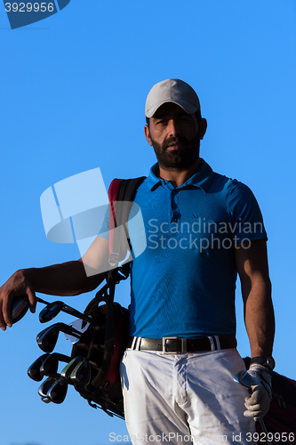 Image of golfer  portrait at golf course on sunset