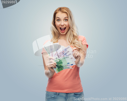 Image of happy young woman with euro cash money