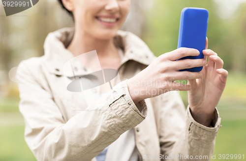 Image of close up of woman taking picture with smartphone