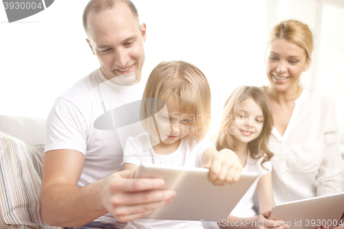 Image of happy family with tablet pc computers at home