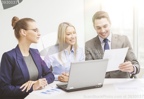 Image of business team with laptop having discussion