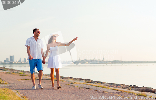 Image of smiling couple walking outdoors