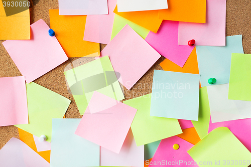 Image of close up of blank paper stickers on cork board