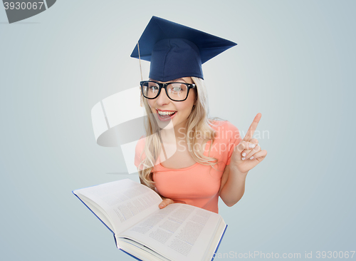 Image of student woman in mortarboard with encyclopedia