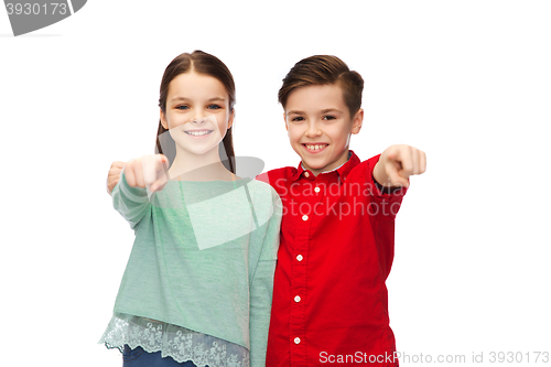Image of happy boy and girl pointing finger to you