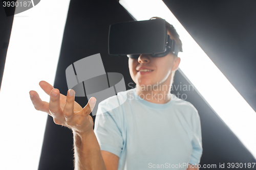 Image of happy man in virtual reality headset or 3d glasses