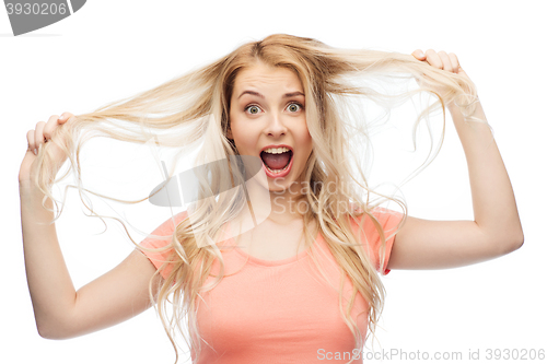 Image of woman holding strand of her hair