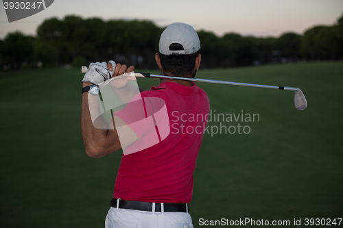 Image of golfer hitting a sand bunker shot on sunset