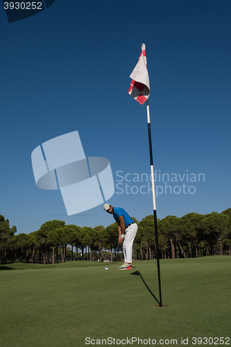 Image of golf player hitting shot at sunny day