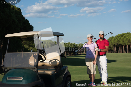 Image of couple in buggy on golf course