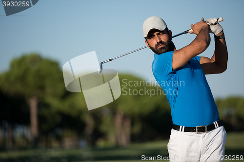 Image of pro golfer hitting a sand bunker shot