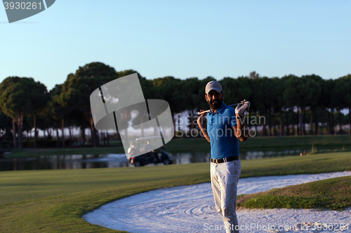 Image of golfer  portrait at golf course on sunset