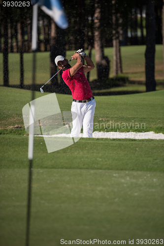 Image of golfer hitting a sand bunker shot