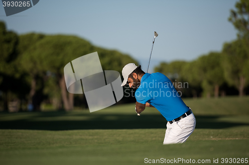 Image of pro golfer hitting a sand bunker shot