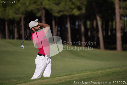 Image of golfer hitting a sand bunker shot