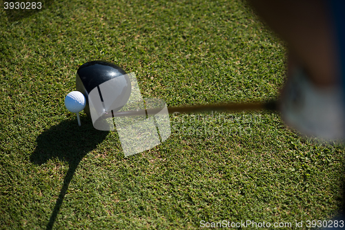 Image of top view of golf club and ball in grass