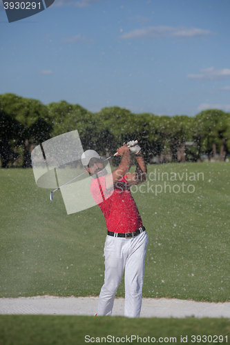 Image of golfer hitting a sand bunker shot