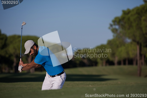 Image of pro golfer hitting a sand bunker shot