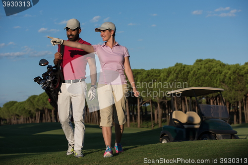 Image of couple walking on golf course