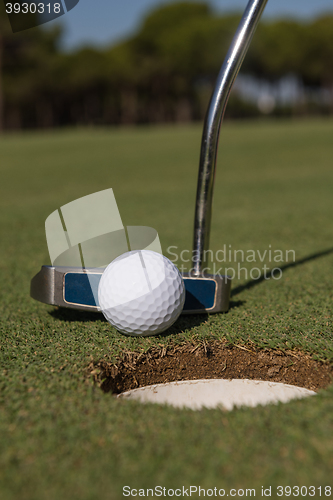 Image of hitting golf ball to hole