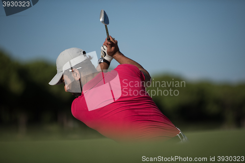 Image of golfer hitting a sand bunker shot