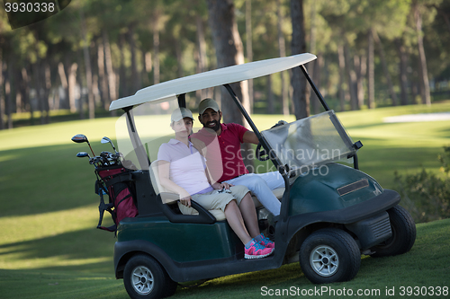 Image of couple in buggy on golf course