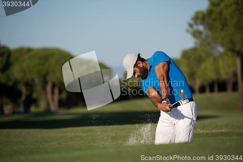 Image of pro golfer hitting a sand bunker shot